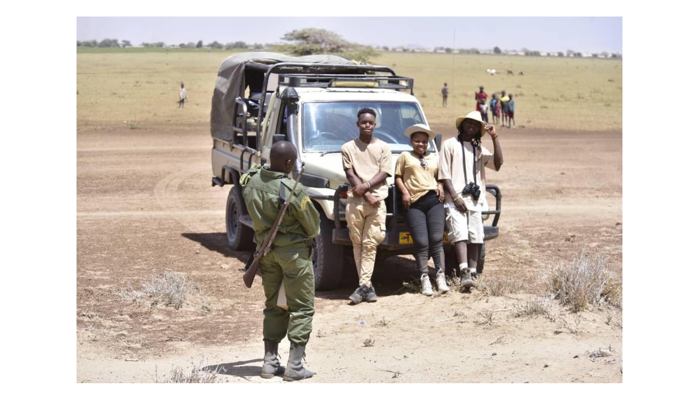 Amri (left) leaning on the car during one of his field trips taking in the sights